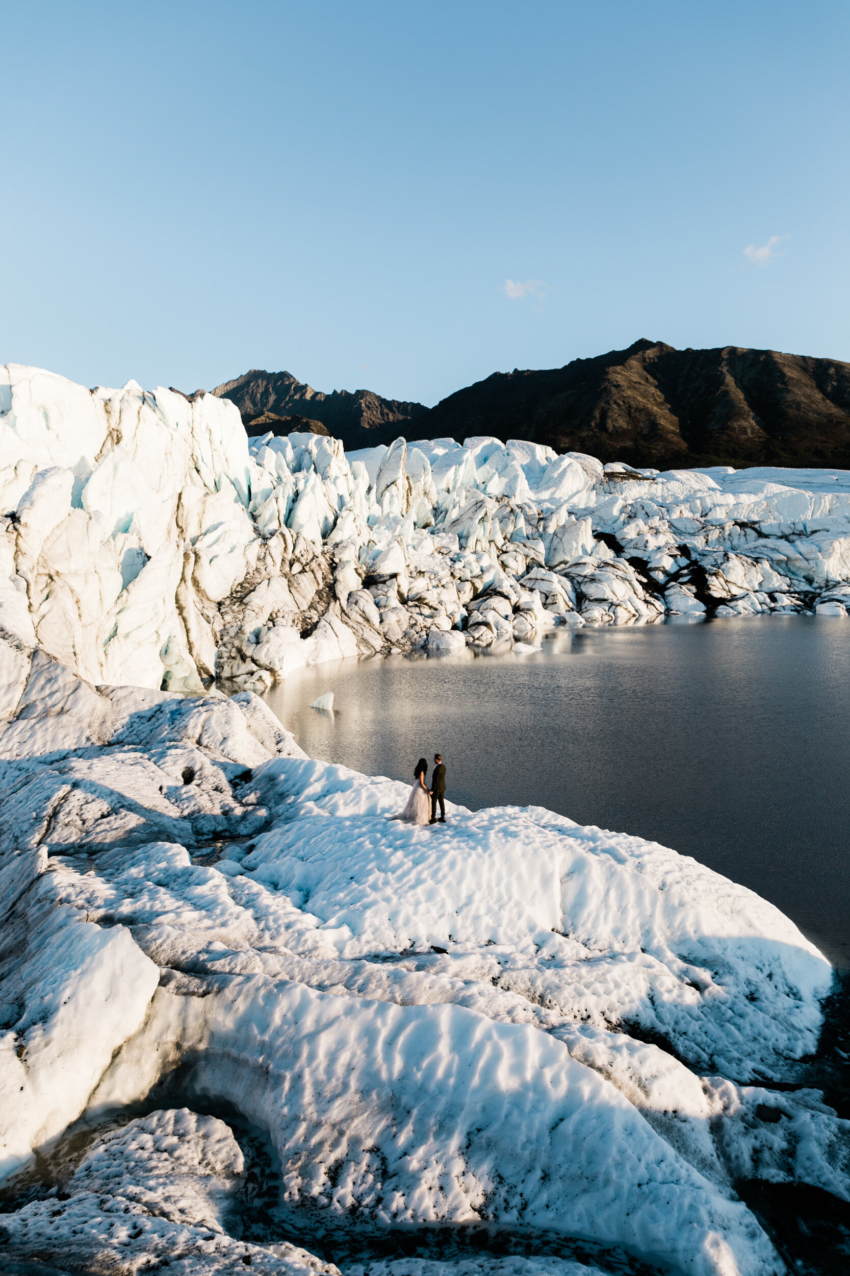 Glacier Hiking Elopement in Alaska | Day-After Wedding Session | Blush Wedding Dress | Dark Green Groom Suit | The Hearnes Adventure Photography