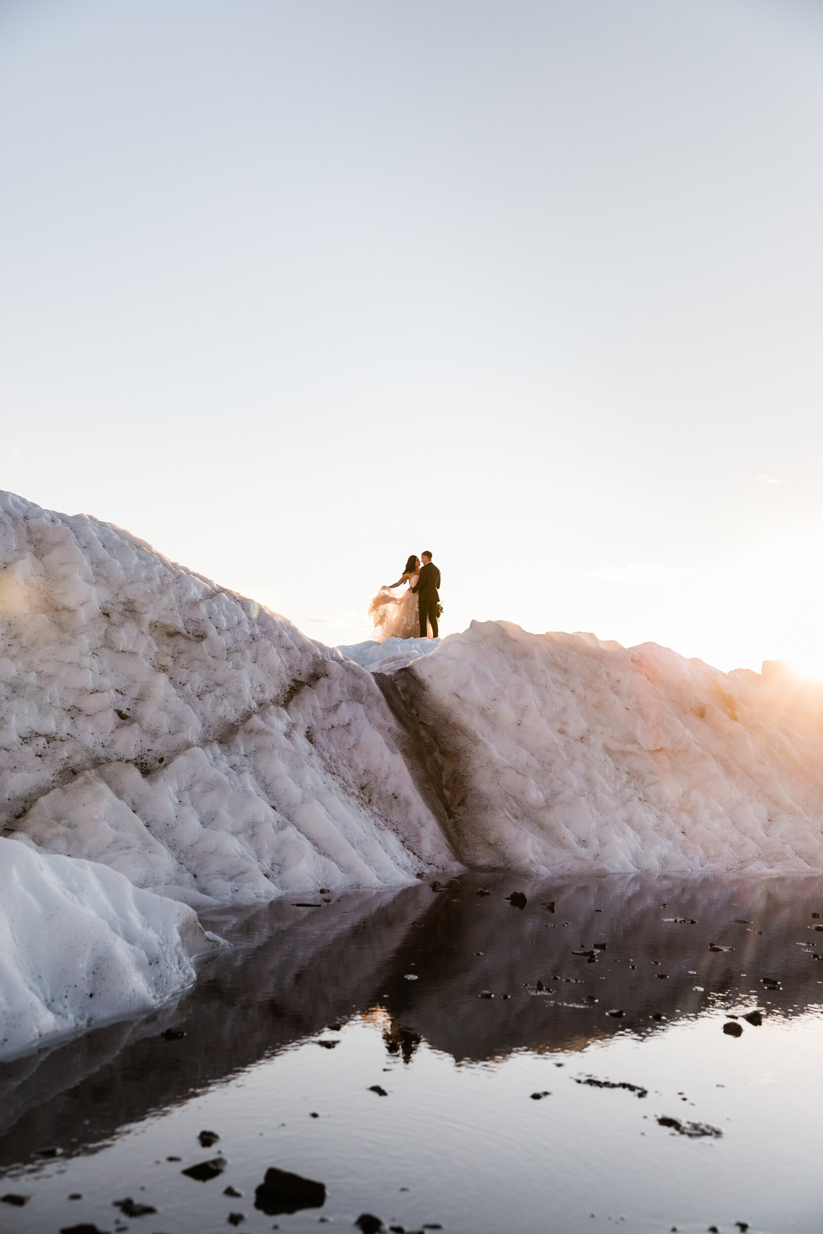 Glacier Hiking Elopement in Alaska | Day-After Wedding Session | Blush Wedding Dress | Dark Green Groom Suit | The Hearnes Adventure Photography