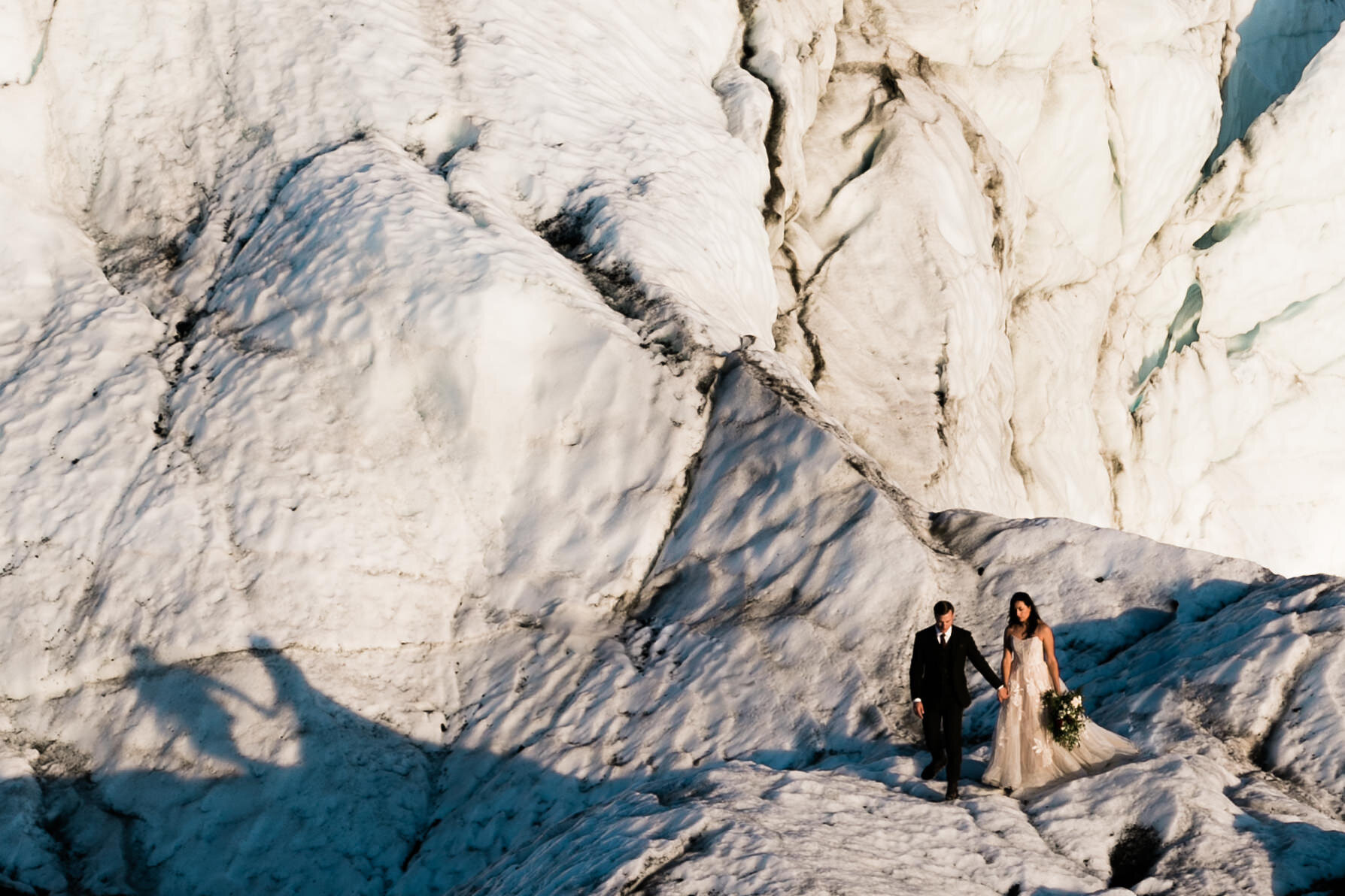 Glacier Hiking Elopement in Alaska | Day-After Wedding Session | Blush Wedding Dress | Dark Green Groom Suit | The Hearnes Adventure Photography