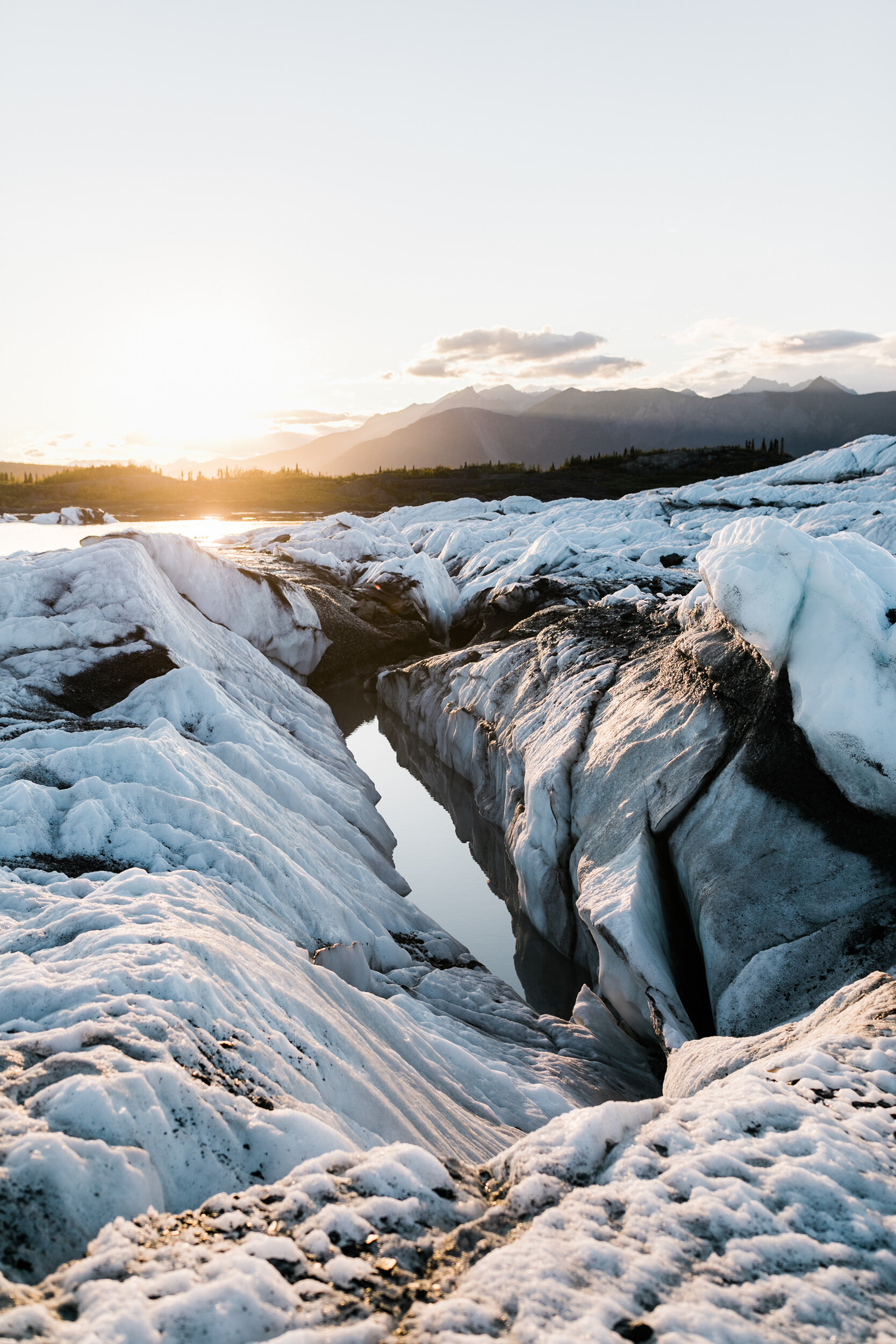 Glacier Hiking Elopement in Alaska | Day-After Wedding Session | Blush Wedding Dress | Dark Green Groom Suit | The Hearnes Adventure Photography