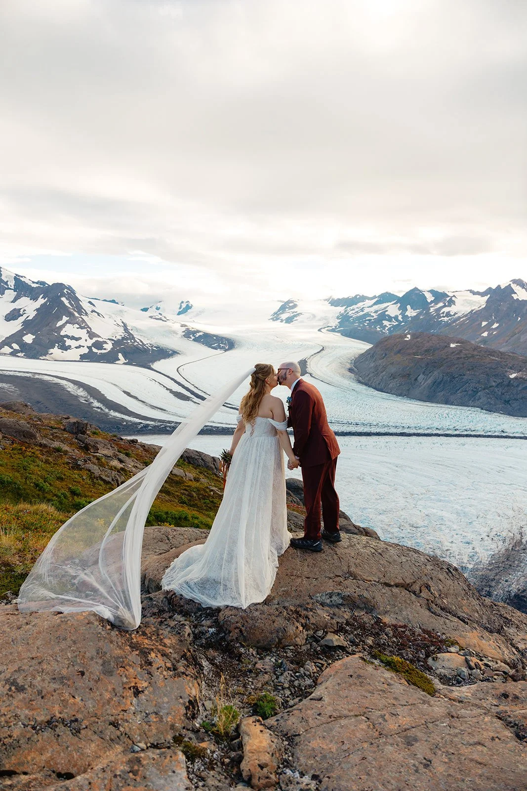 Alaska micro wedding elopement with a helicopter flying to glaciers and mountain tops with The Hearnes Photography
