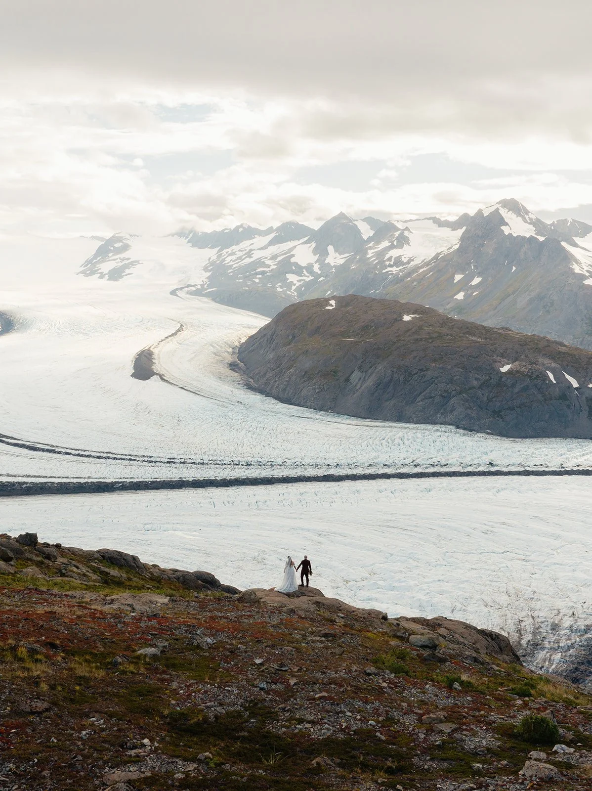Alaska micro wedding elopement with a helicopter flying to glaciers and mountain tops with The Hearnes Photography