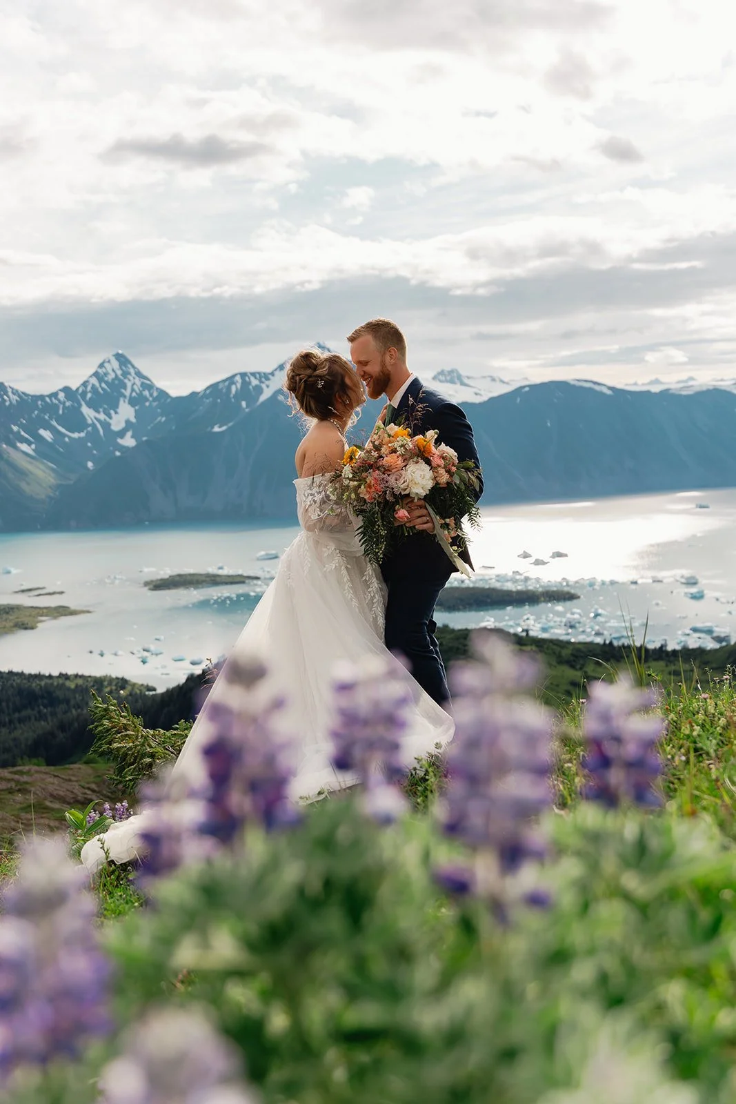 Alaska micro wedding elopement with a helicopter flying to glaciers and mountain tops with The Hearnes Photography