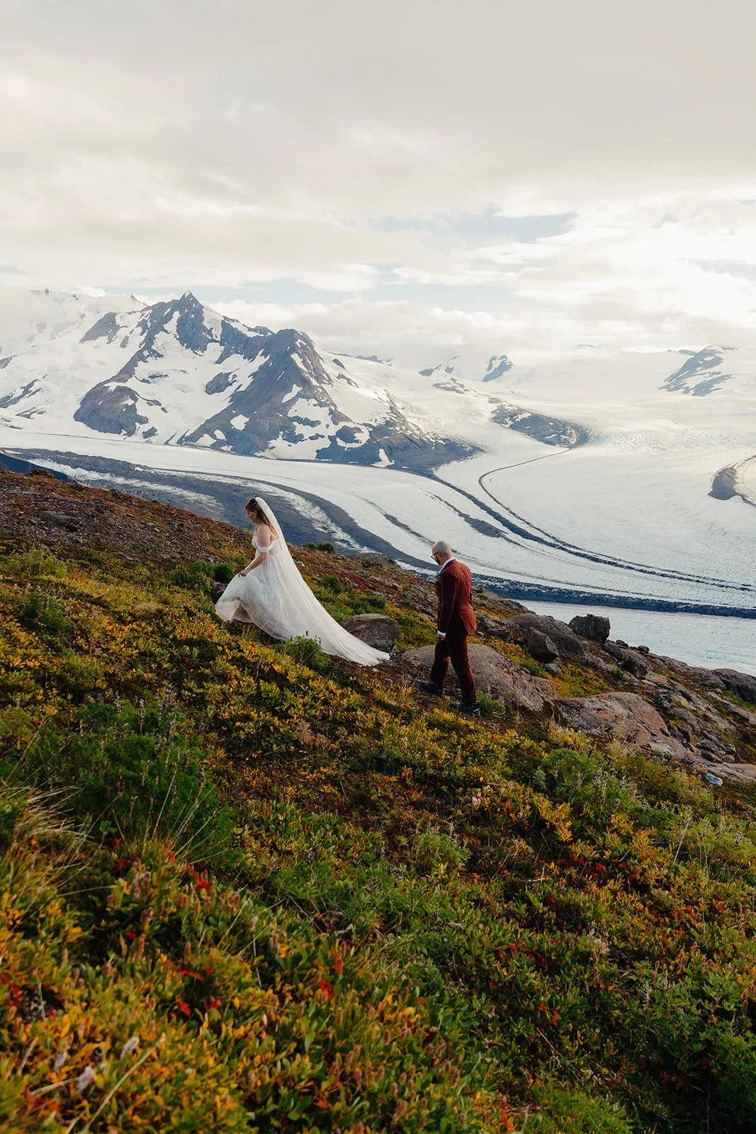Alaska micro wedding elopement with a helicopter flying to glaciers and mountain tops with The Hearnes Photography