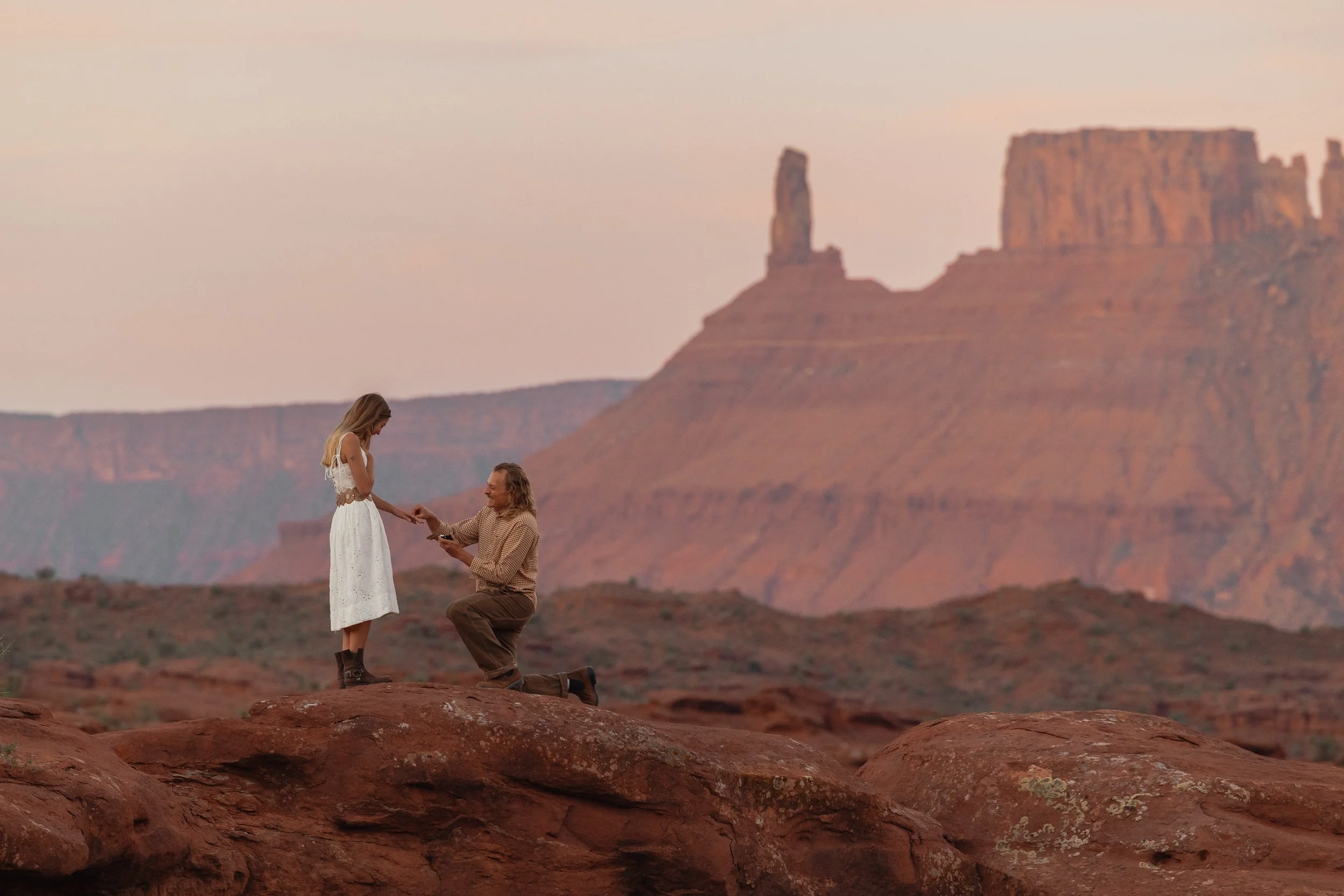 Rachel Harris @sunnrayy + Tanner Price @tanner.price_ engaged in Moab, Utah | sunrise surprise proposal with The Hearnes