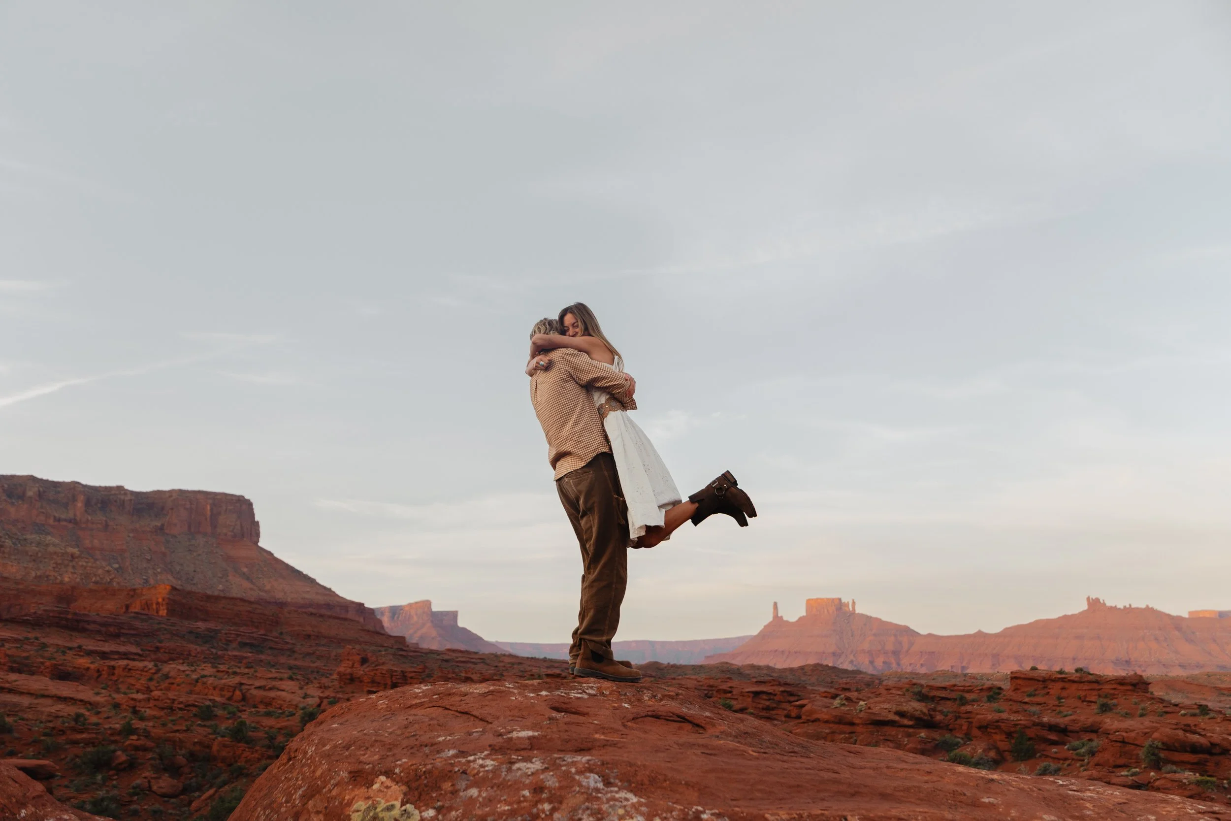 Rachel Harris @sunnrayy + Tanner Price @tanner.price_ engaged in Moab, Utah | sunrise surprise proposal with The Hearnes