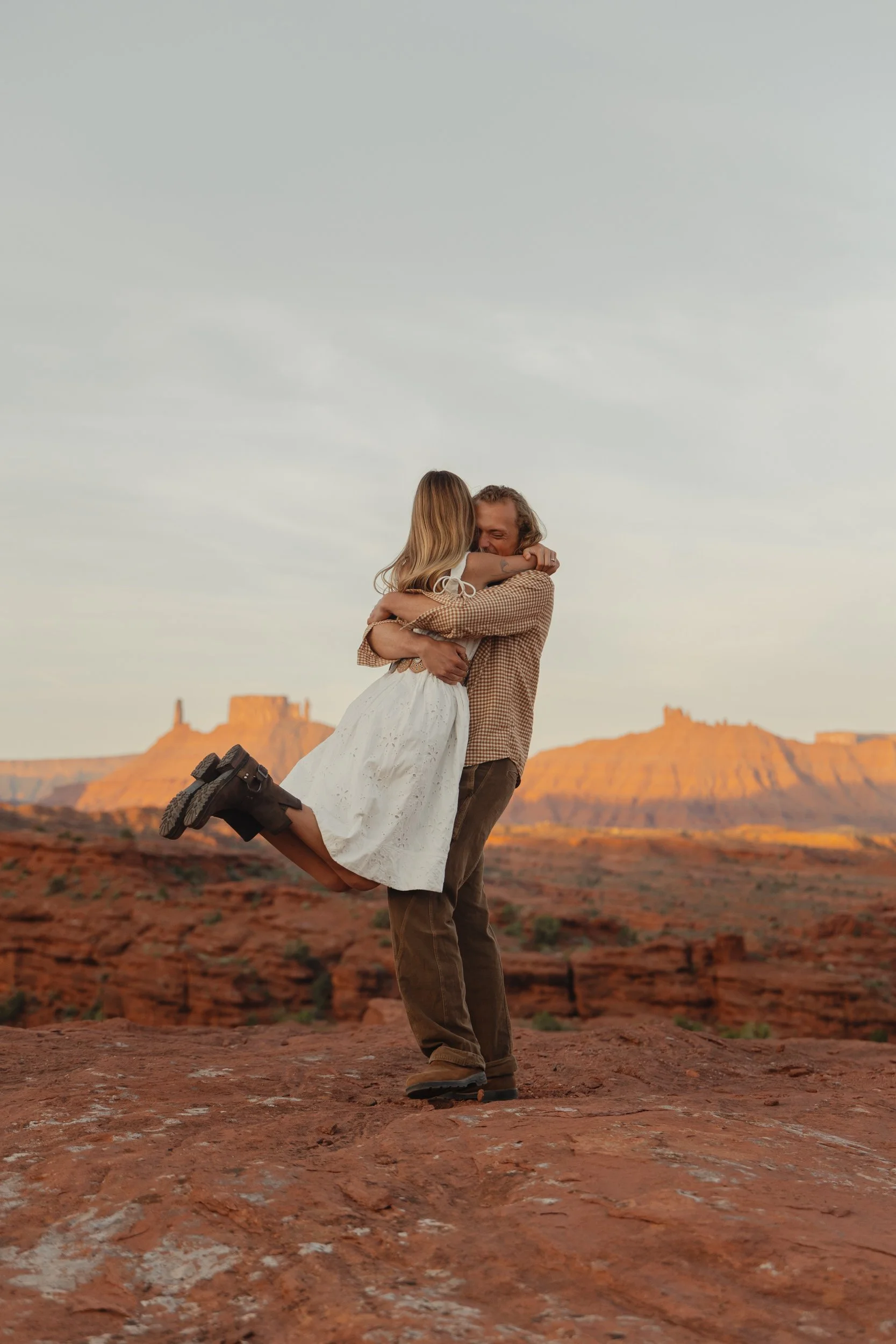 Rachel Harris @sunnrayy + Tanner Price @tanner.price_ engaged in Moab, Utah | sunrise surprise proposal with The Hearnes