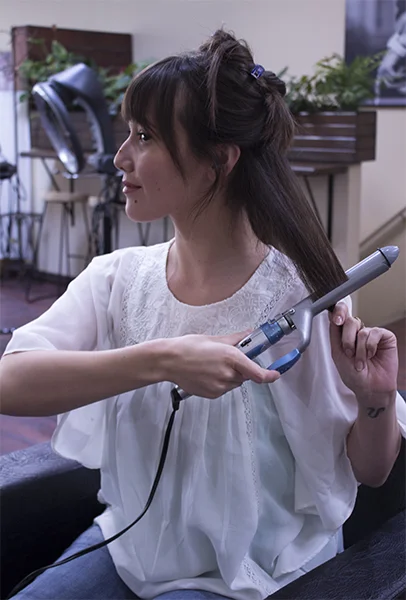 2) Grab a section of hair, using a curling iron, start from the bottom and roll iron forward. 3) Repeat for middle area.