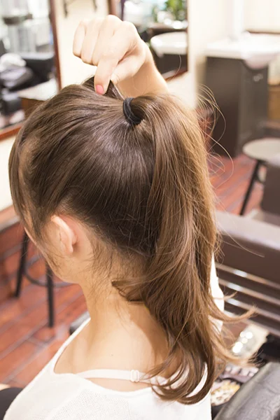2. Using your fingertips, pinch hair to add shape.