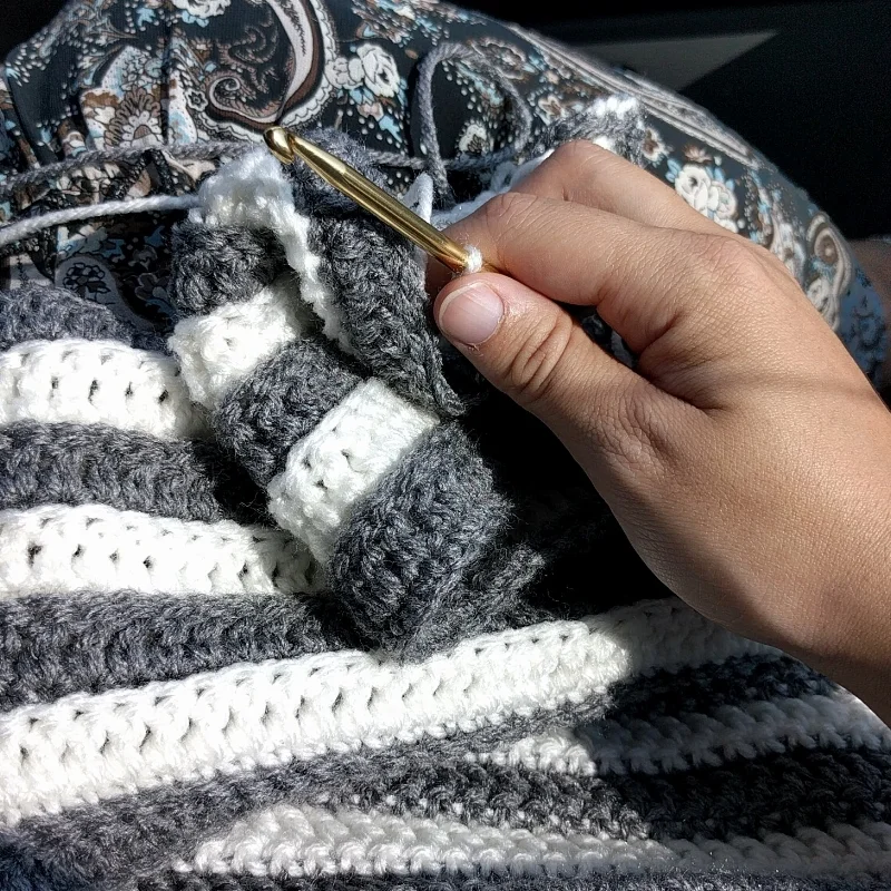 Working on the blanket in the car.