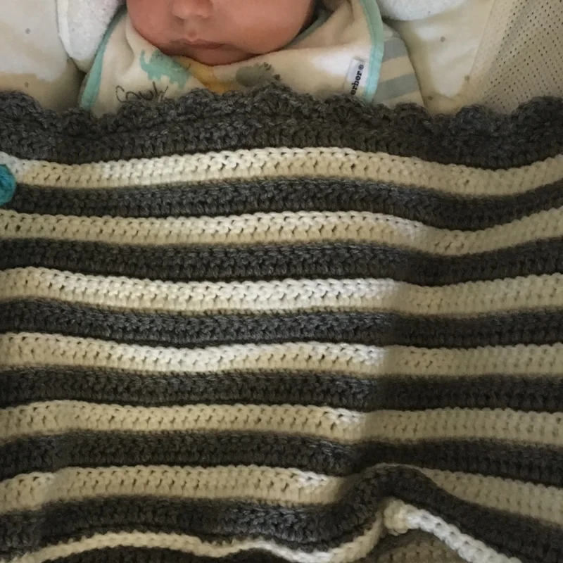 Baby enjoying his blanket.