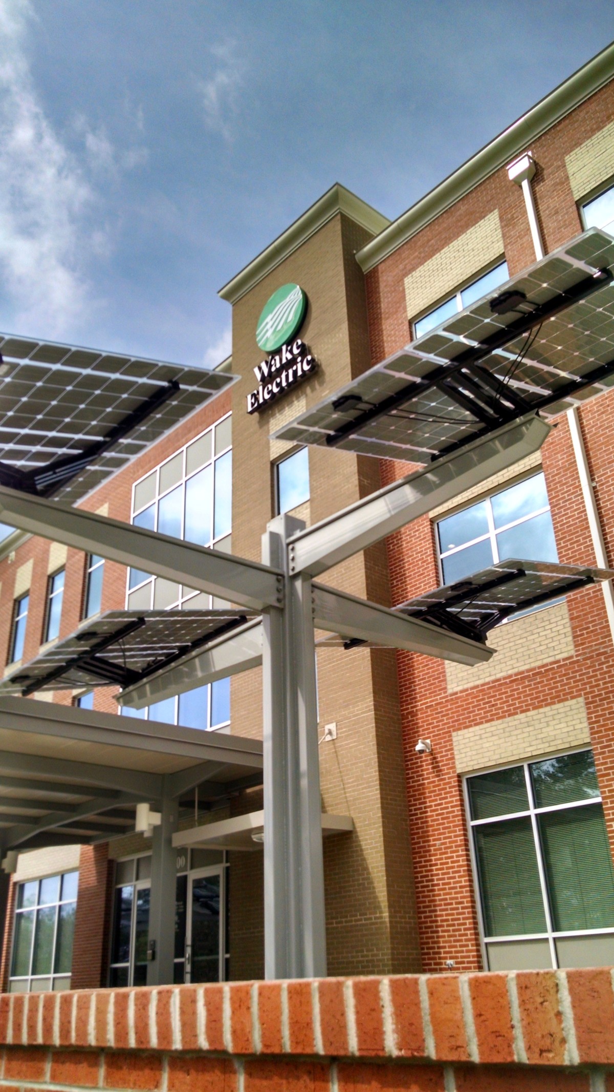 wake electric logo with spotlight solar industry.jpg