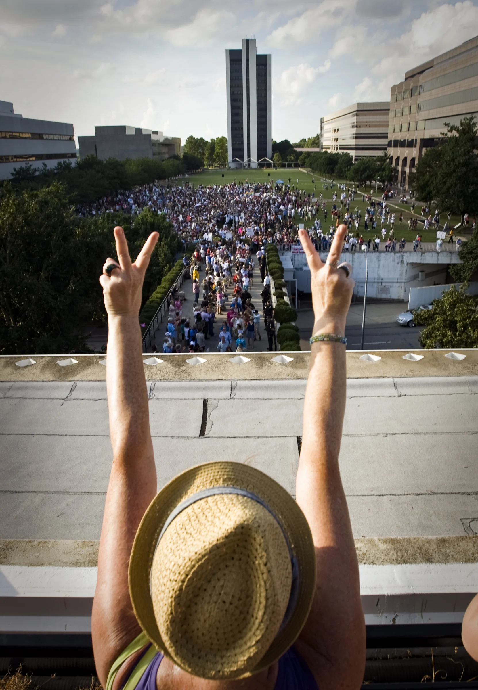  A supporter cheers on protesters as they move from Halifax Mall into the North Carolina Legislature during the twelfth Moral Monday protest on Monday, July 22, 2013, in Raleigh, N.C.&nbsp; 