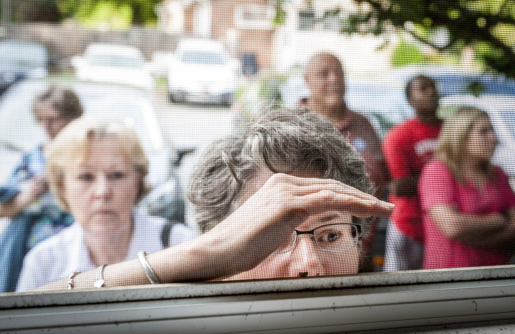  Martha Hartley, of Stokes County, attempts to listen to a standing room only meeting of the Walnut Cove commissioners through a window. The meeting was packed to capacity with residents of Walnut Cove objecting to plans to bring fracking to their co