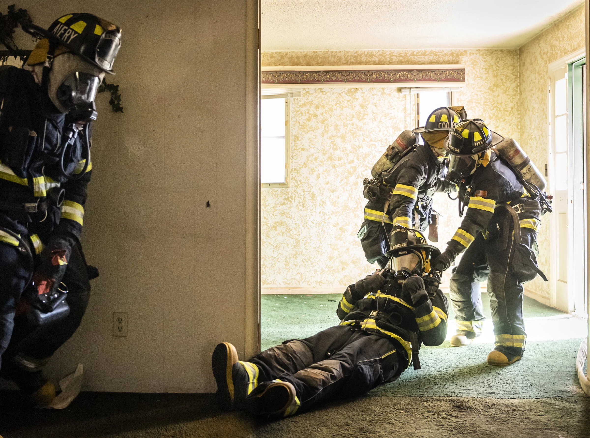  Recruits with the Winston-Salem Fire Department recruit class XXVII, from left, Ricky Cooper and Cody Joyner drag fellow recruit Samuel Harvey out of a structure during R.I.T. training as Micheal Avery trails with the R.I.T. bag and other gear on Mo