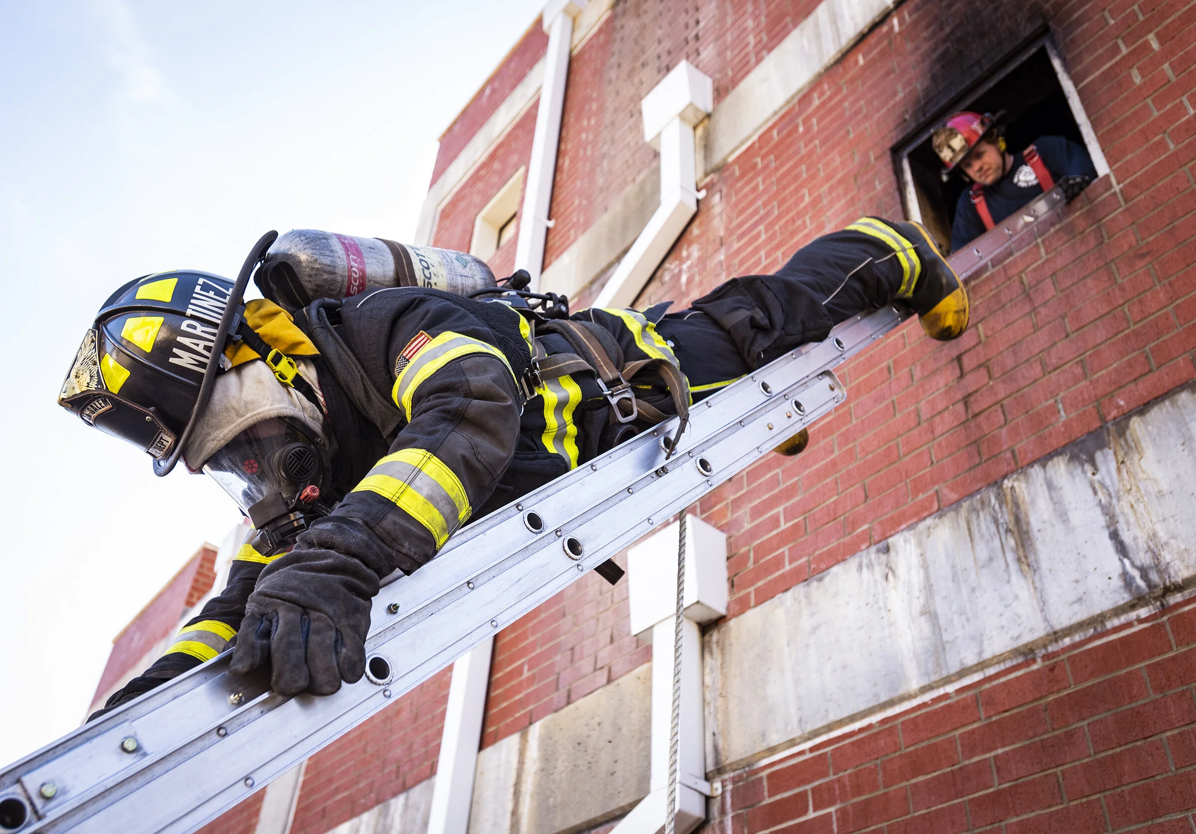  Juan Martinez, a recruit with Winston-Salem Fire Department recruit class XXVII, evacuates a structure headfirst down a ladder during training on Tuesday, Feb. 5, 2019 in King, N.C. 