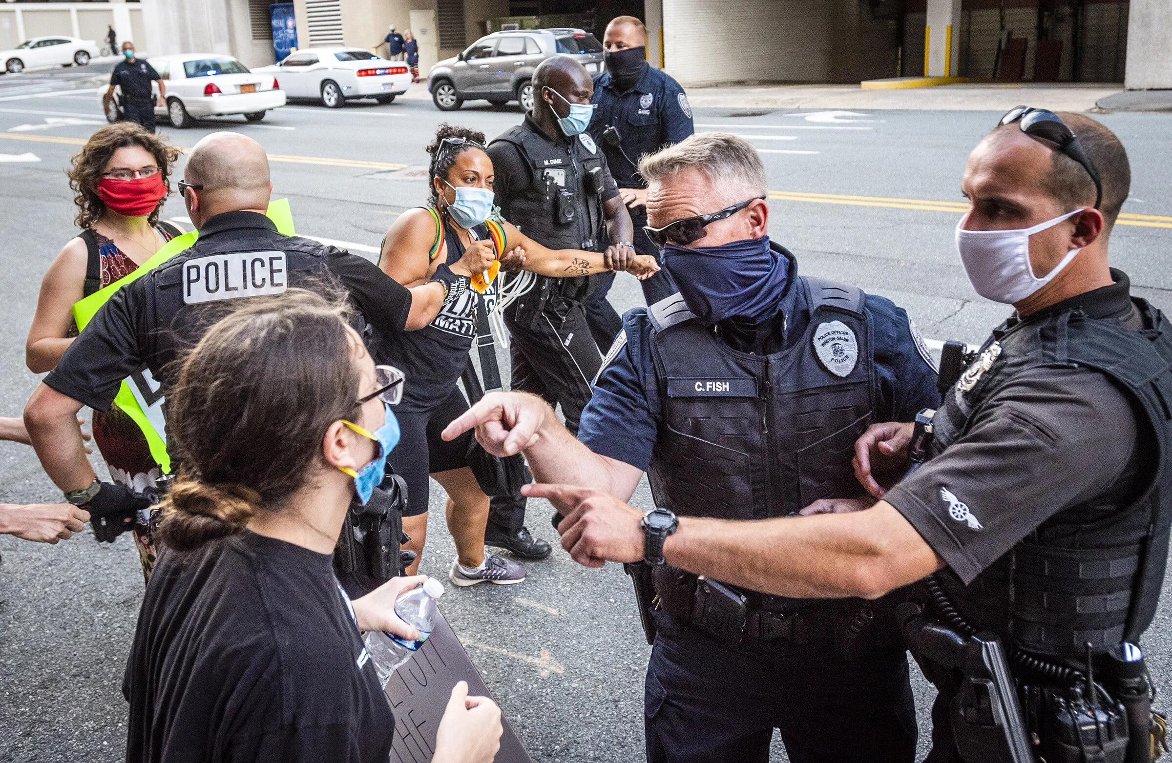  Officers with the Winston-Salem Police Department arrest Brittany Battle during a protest over the death of John Neville in the Forsyth County Jail on Wednesday, July 8, 2020 in Winston-Salem, N.C. 