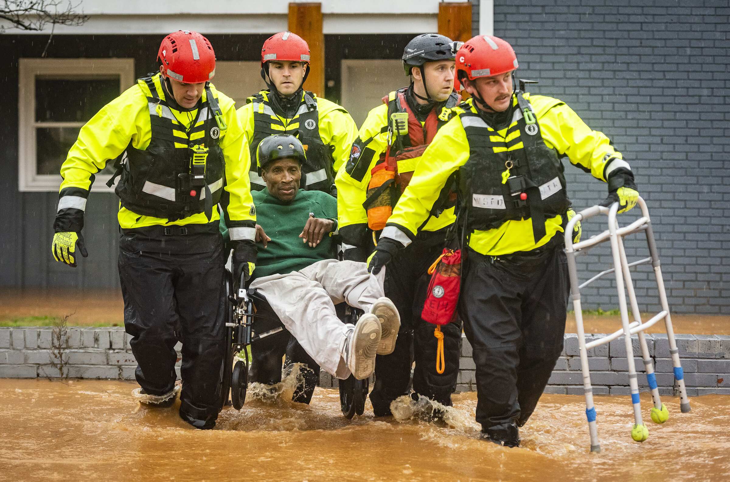  Winston-Salem Fire Department firefighters with the Rescue Task Force rescue James Benjamin from his home at Liberty Landing Apartments as flood waters rise around the building on Thursday, Feb. 6, 2020 in Winston-Salem, N.C.  