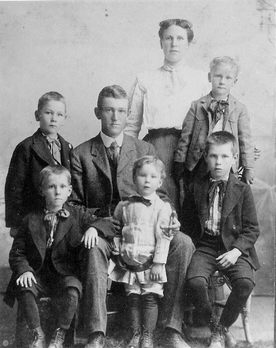 Front row, L-R: Keon Keith; Paul Elry; Eugene Agustus Middle row, L-R: Kenneth Clay; Thomas Andrew Jones; William Carl Back row: Eva Hyde Jones Twins Lewis Irwin and Harvey Darwin are not shown Undated photo, circa 1906, unknown location