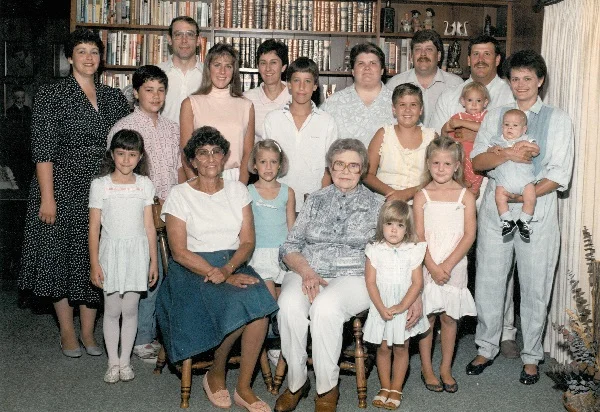 Descendants through Maynard L. Jones, 1985, 10 S. Oak Park, Colfax, Iowa Front row, L-R: Amber D. Fauvelle; B. Lou Barkus Jones; Laurel Garrett; Zita Shutts Jones; EricaL. Jones; Desiree N. Jones Middle row, L-R: Gabriel C. Fauvelle; Megan E. Garrett; Evn Garrett; Danielle N. Jones; Karla Thompson Jones holding Connor A. Jones Back row, L-R: Marna Jones Fauvelle; Craig Garrett; Kendra Jones Garrett; Debra Clark Jones; Jeffrey L. Jones; Todd L. Jones holding Chelsie D. Jones