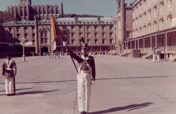 Craig Garrett as Guidon Bearer for Co. B-1, Oct 1967 Central Area with view of clock tower. Cadet Chapel seen above Central Area Barracks