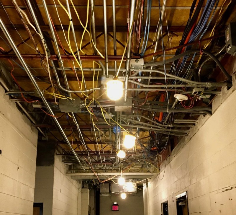 Exposed wiring as workers rebuild the original portion of the Adler Athletic Complex