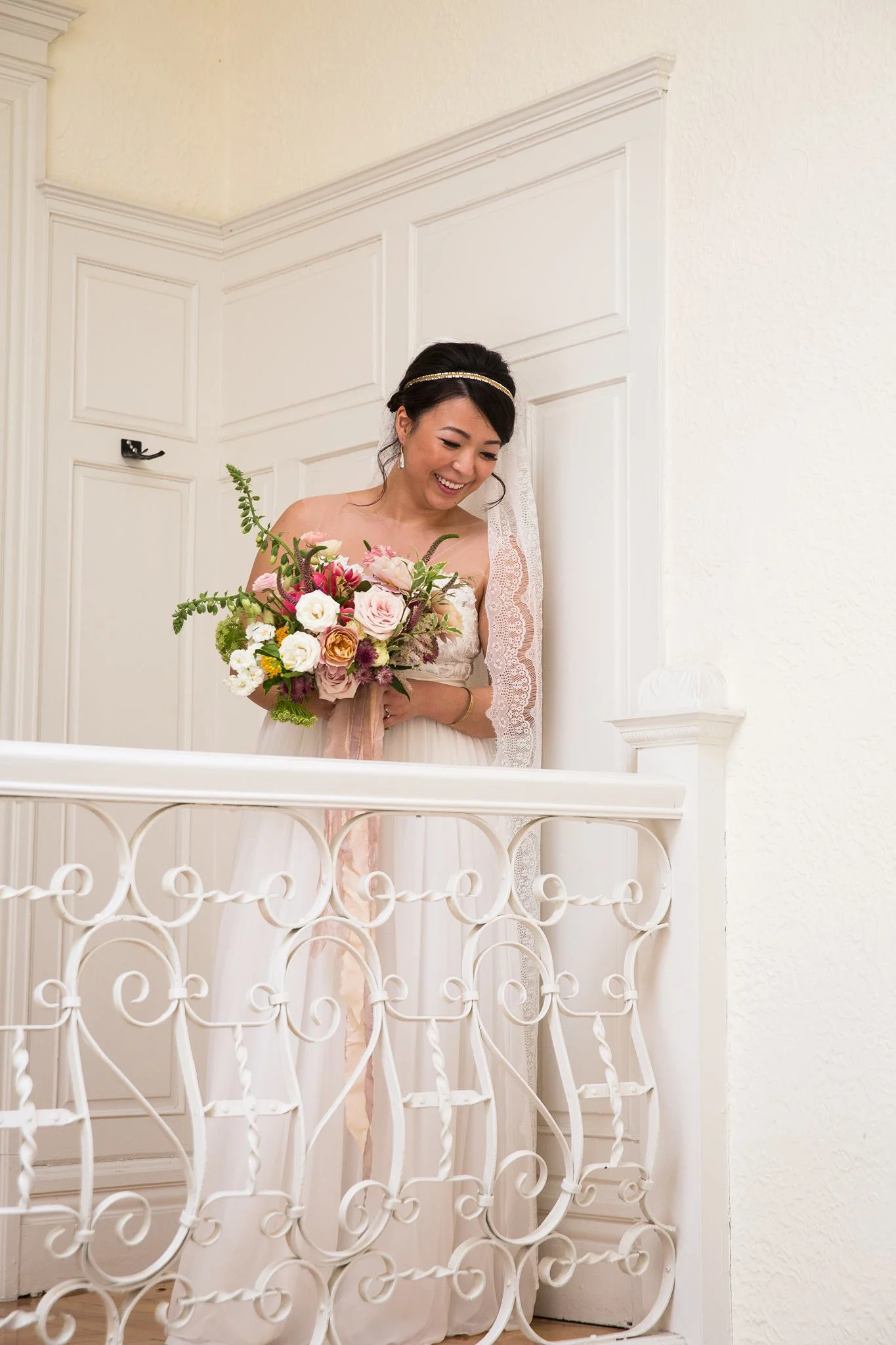 Chloe wearing the Isle of Ely veil - A full lace ivory veil with scalloped edging