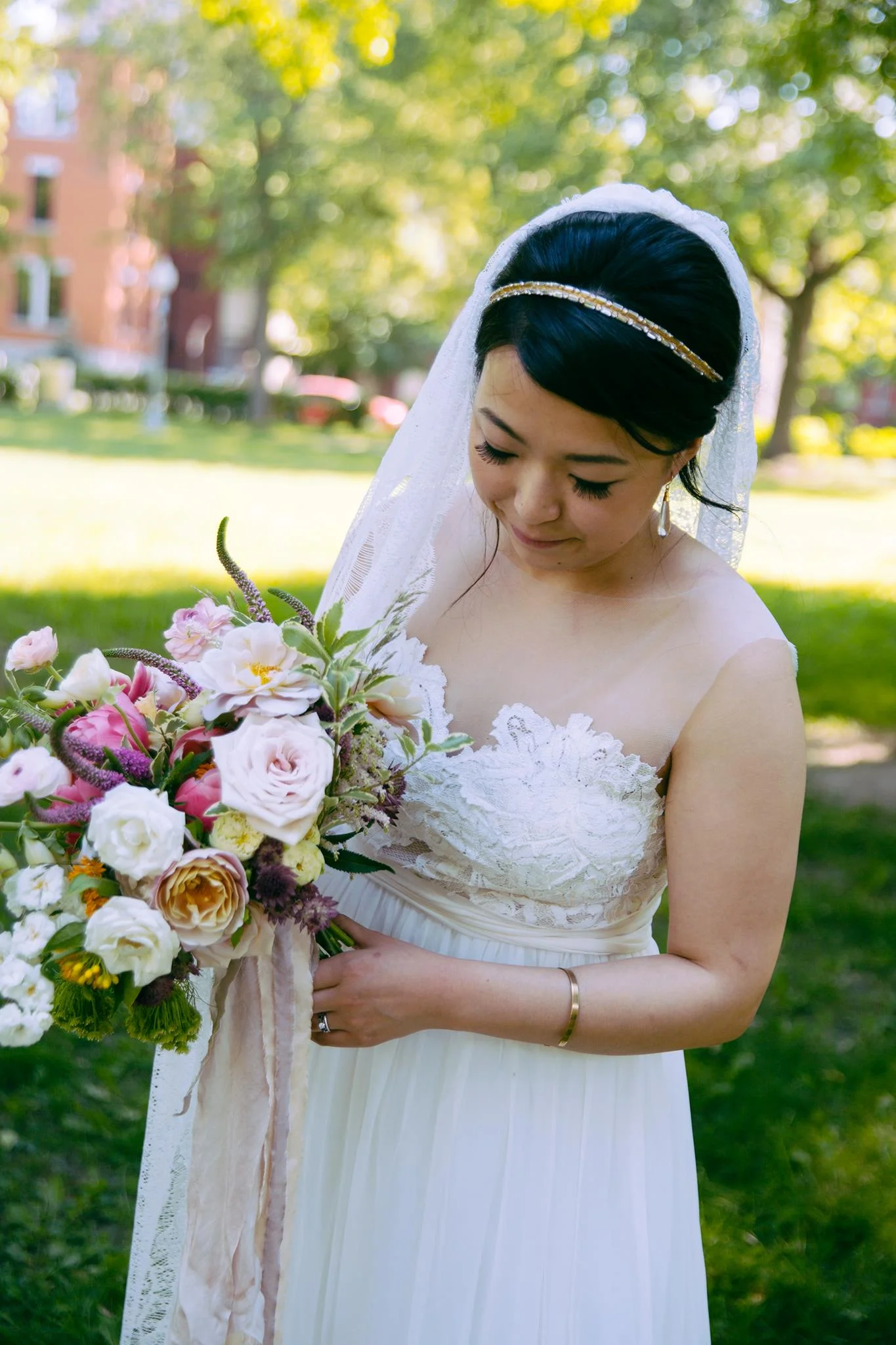 Chloe wearing the Isle of Ely veil - A full lace ivory veil with scalloped edging
