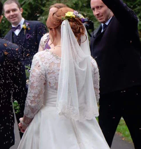 Charlie wearing the Padstow veil - elbow length polka dot veil finished with a floral lace
