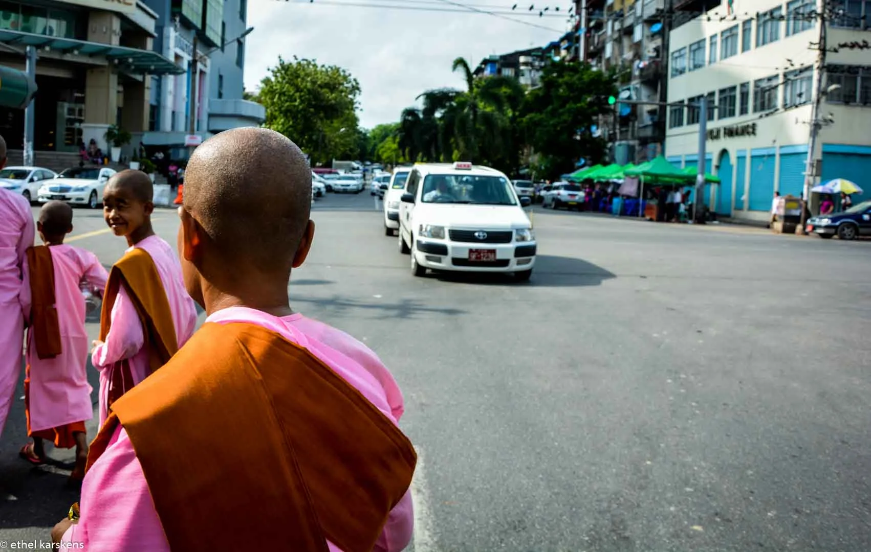 Girls running the alms in Yangon