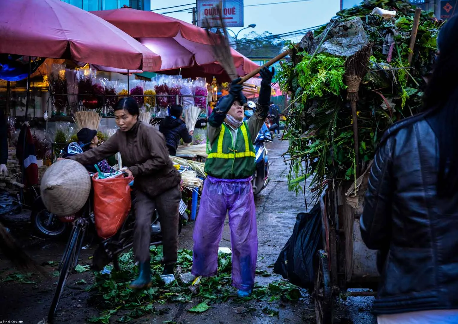 Woman cleaning the the flower market