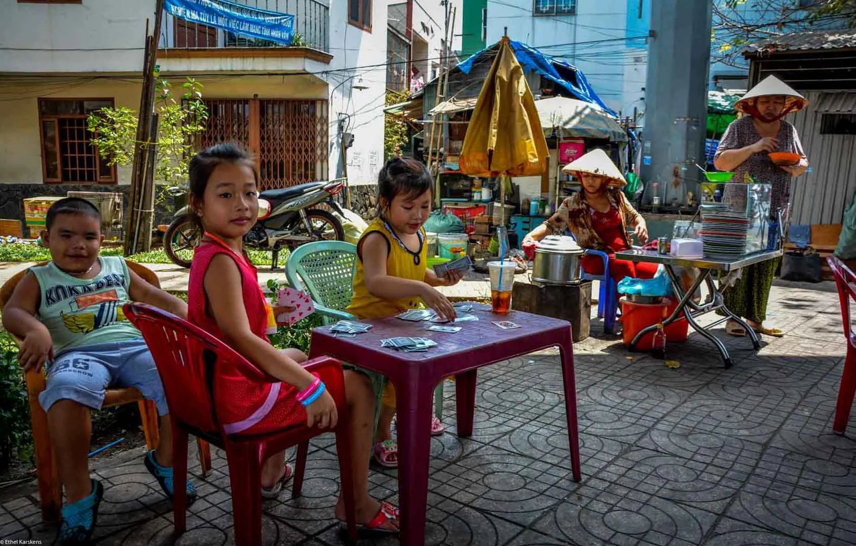 Girl playing cards (District eight, Saigon)