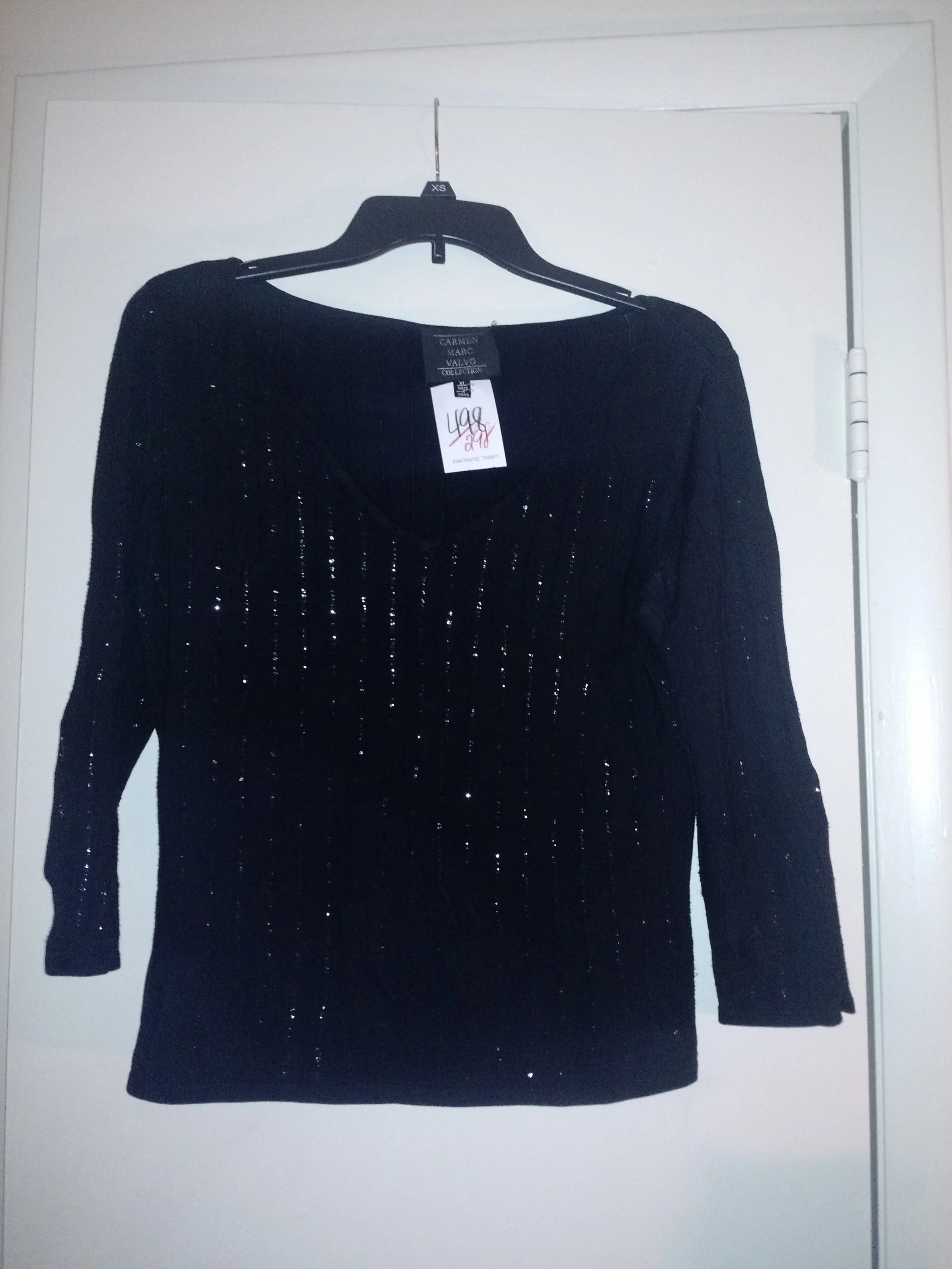 This is a simple black 3/4 sleeve shirt. Sequins done right! A shirt like this is perfect for Christmas and the holidays