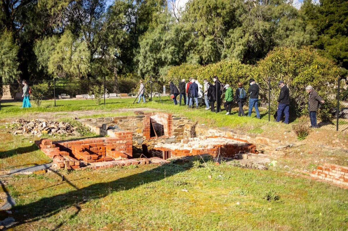 Examining the excavated ruins of the 1903 crematorium during the Guided Walk. Pic: Carla Caruso