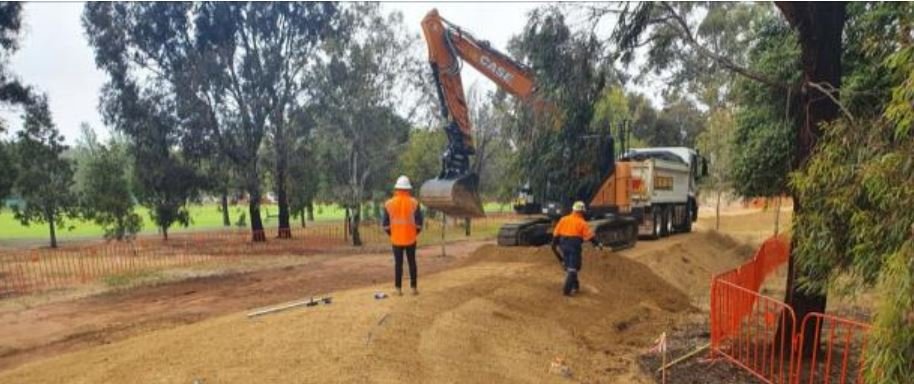 trimming the edges of the containment mound Dec 2021.JPG