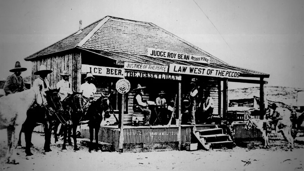 vintage photo of Jersey Lily (Bean is man seated on barrel wearing sombrero)