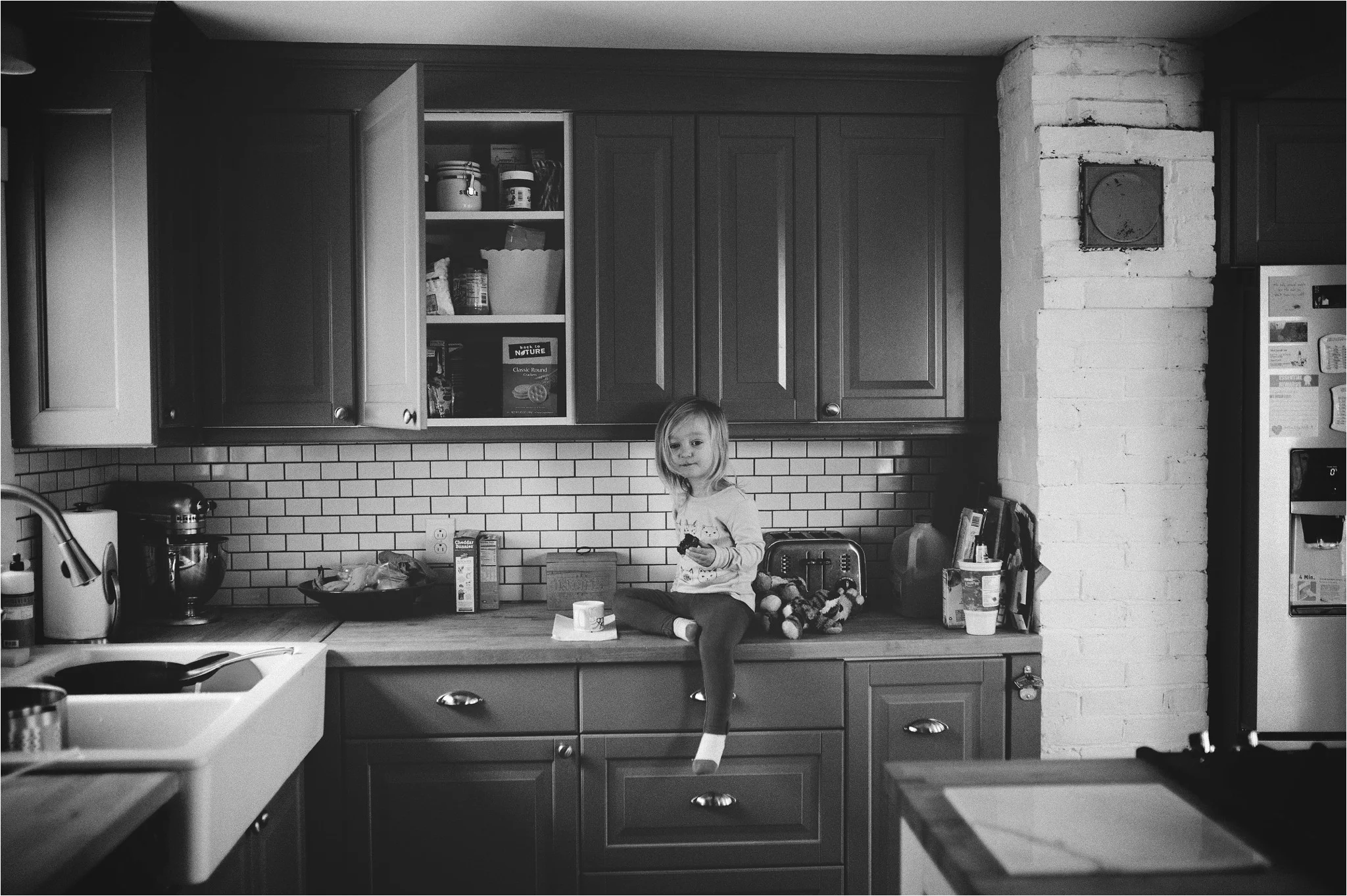little girl sitting on the kitchen counter