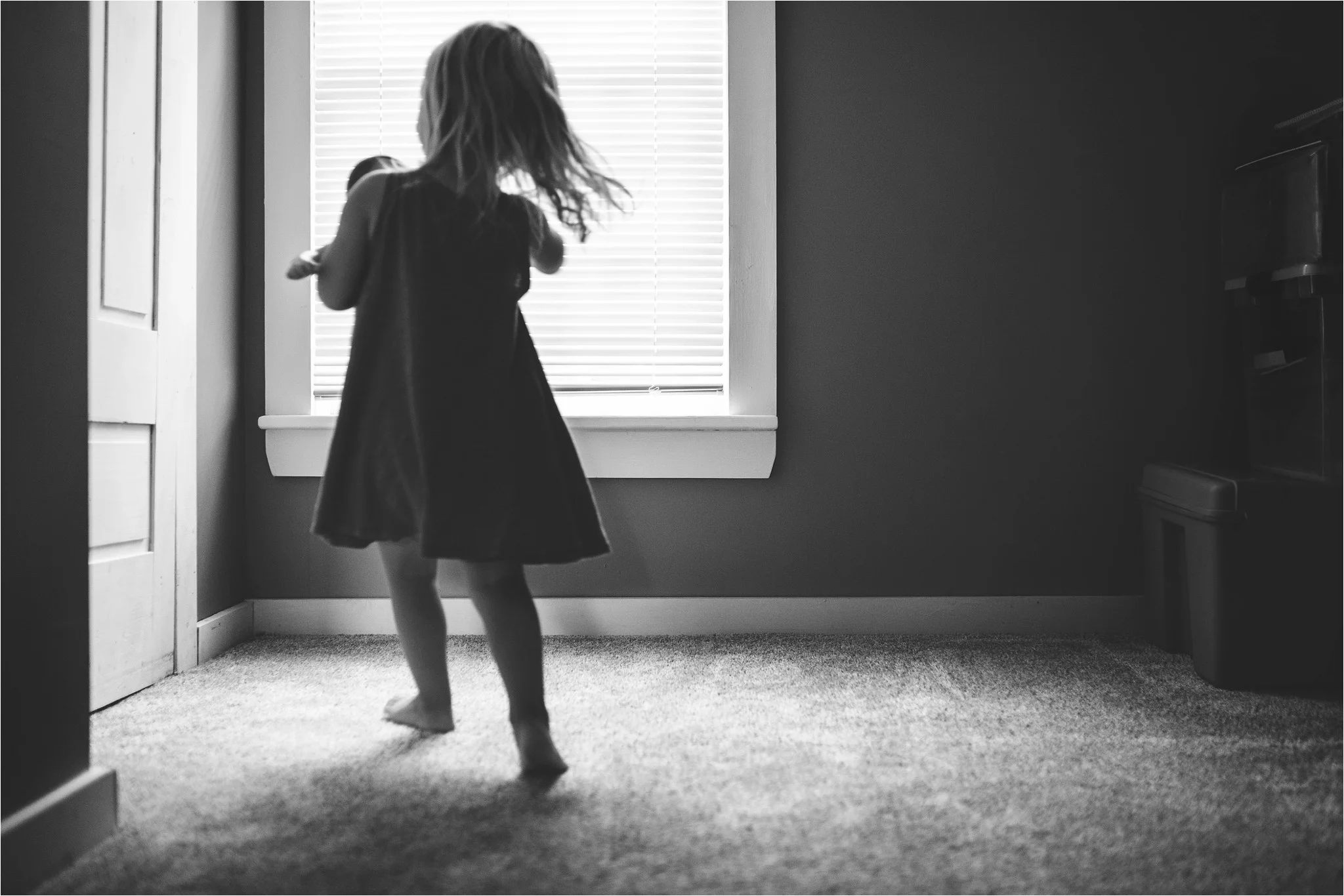 little girl running by the window