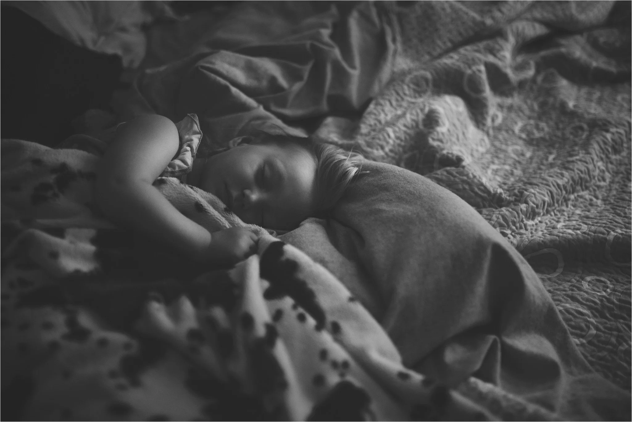 little girl sleeping in bed