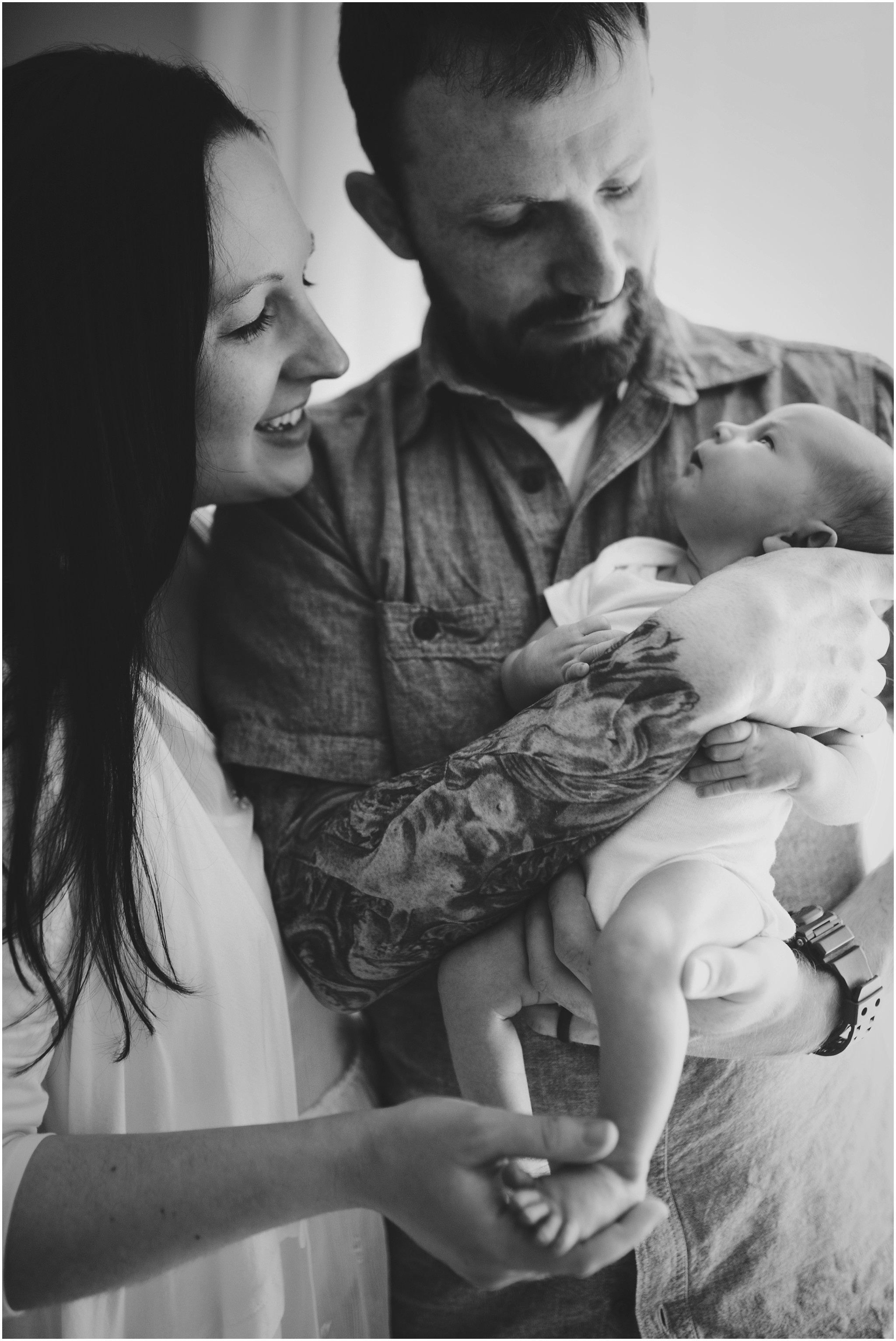 mom and dad holding their baby