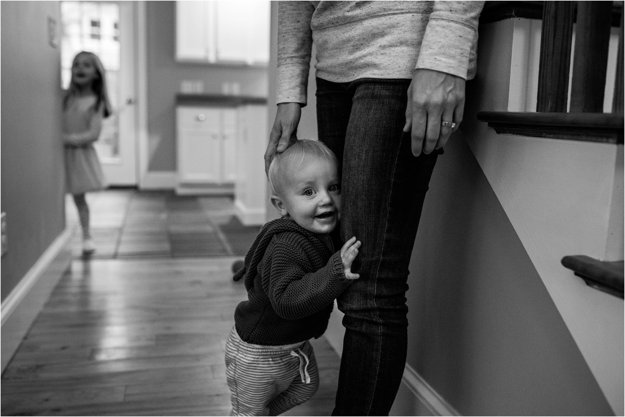 little boy grabbing mom's leg