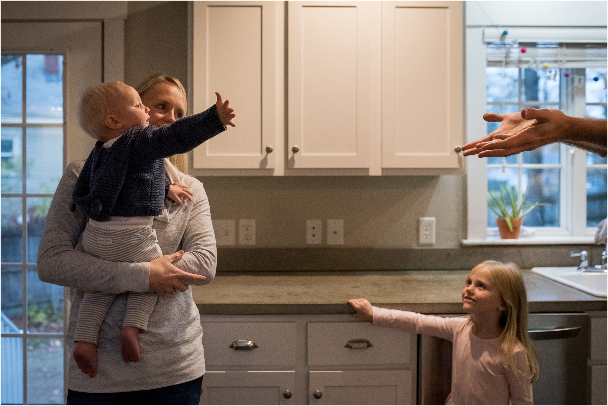 baby reaching for dad's hands