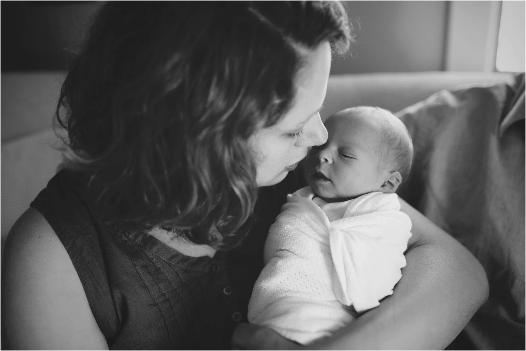 mom kissing baby