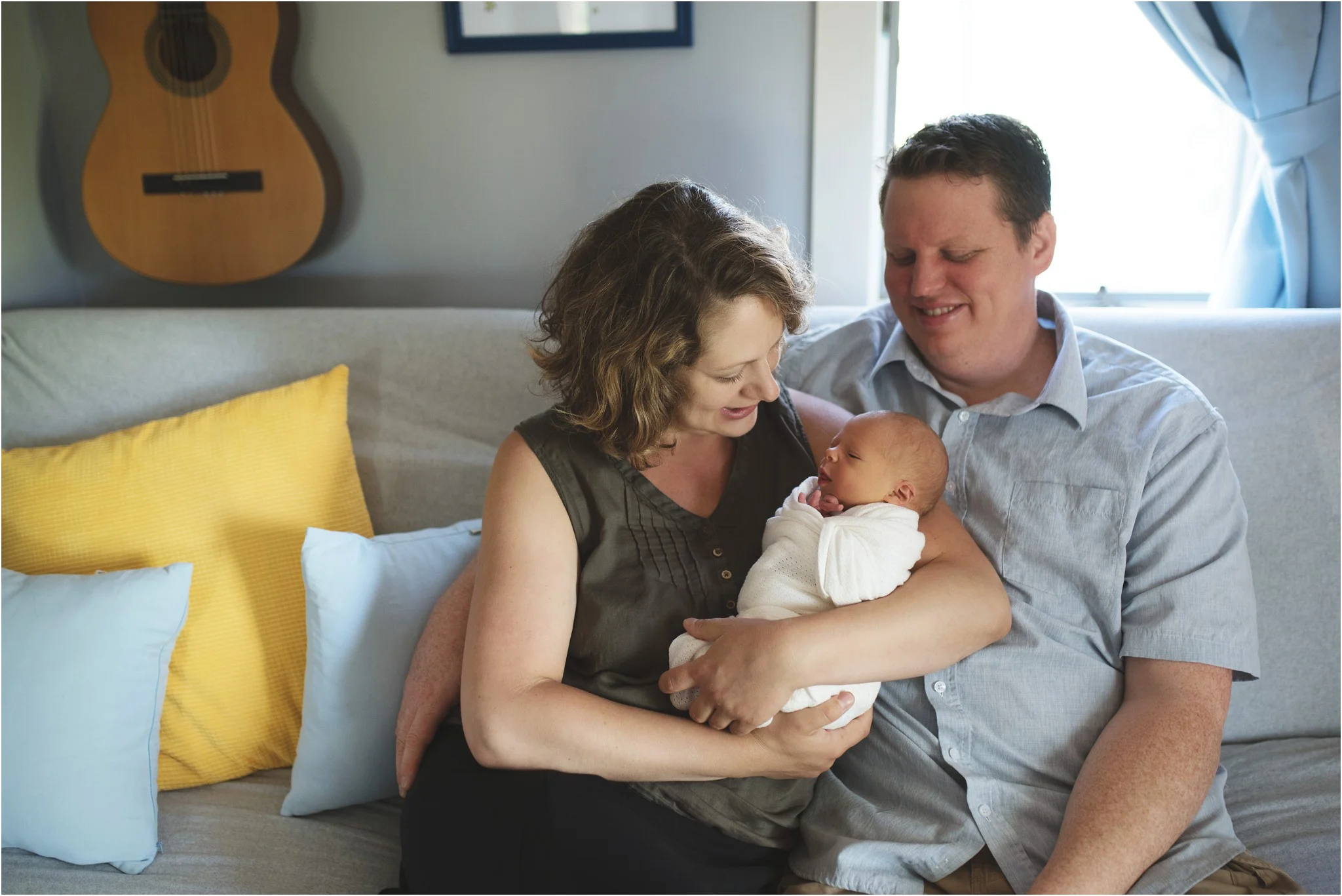 mom and dad holding baby