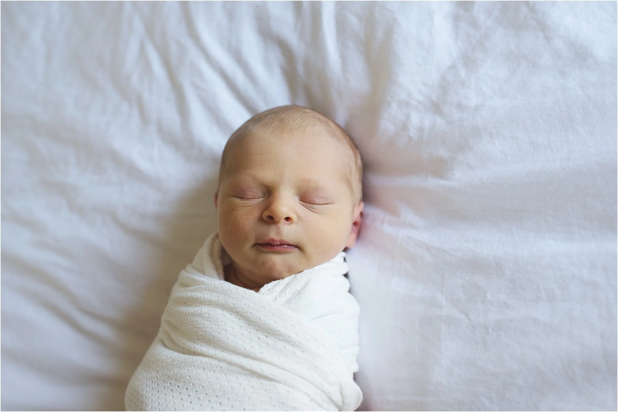 baby laying on the bed