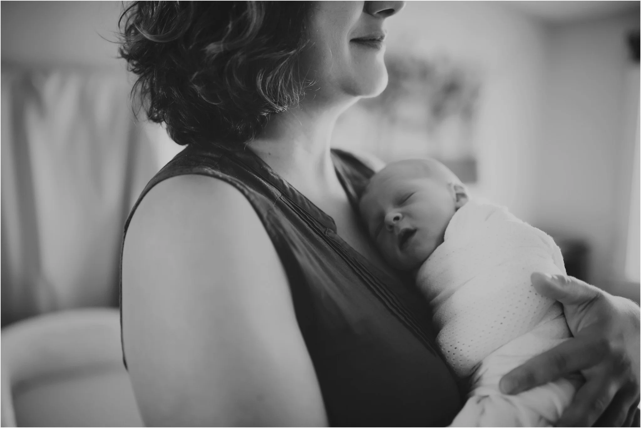 baby laying againsts mom's chest