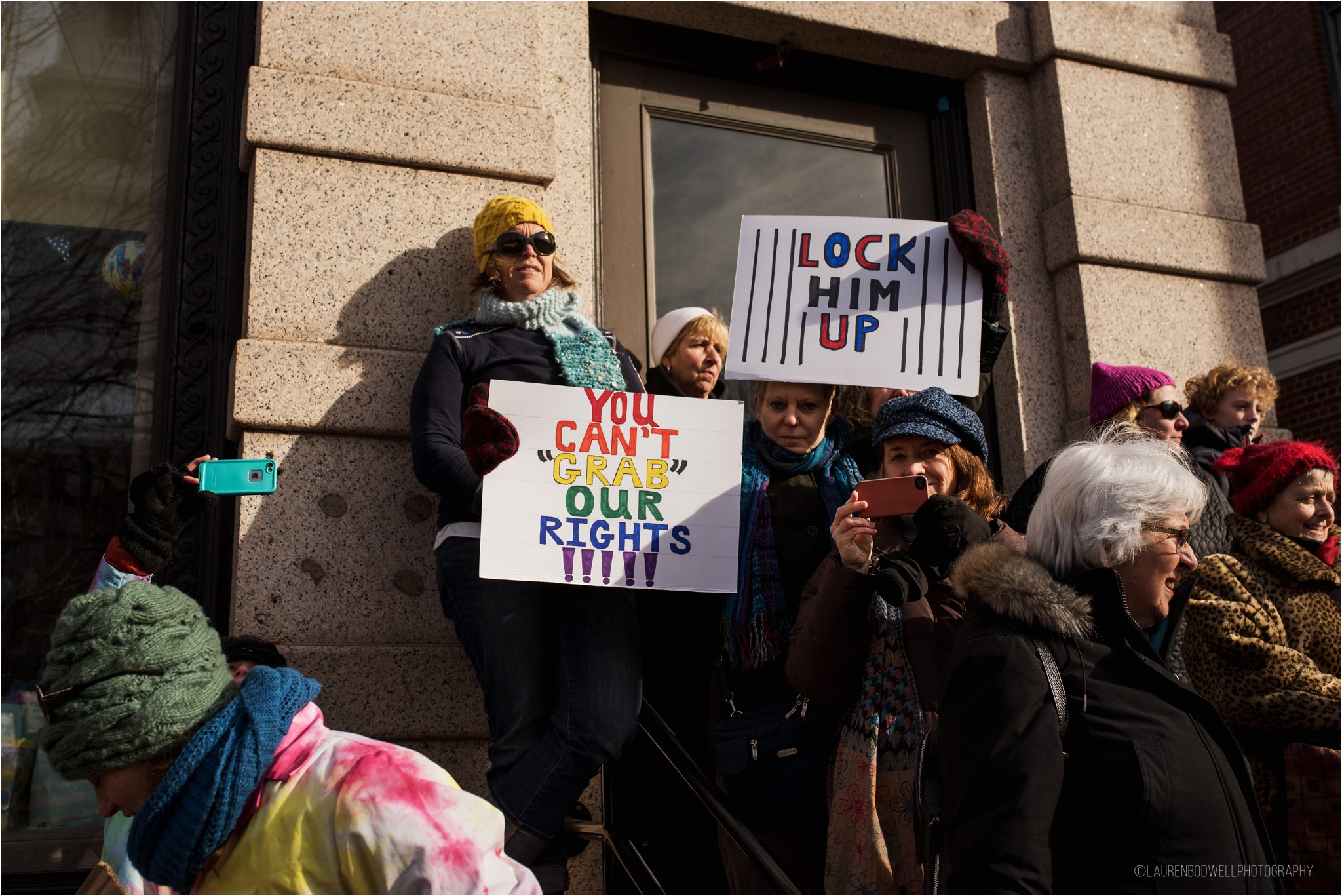 women holding coloful signs