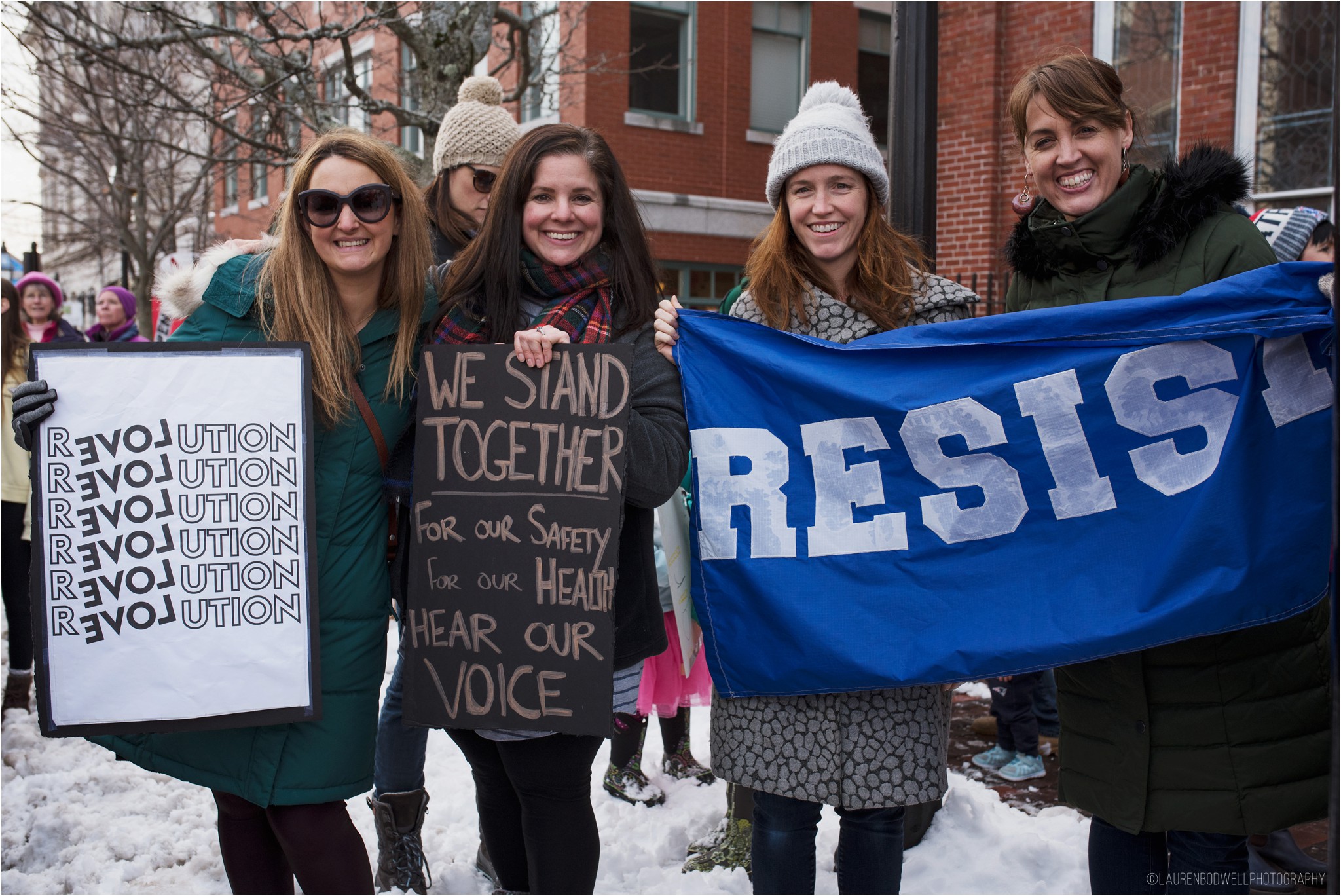 four women holding signs