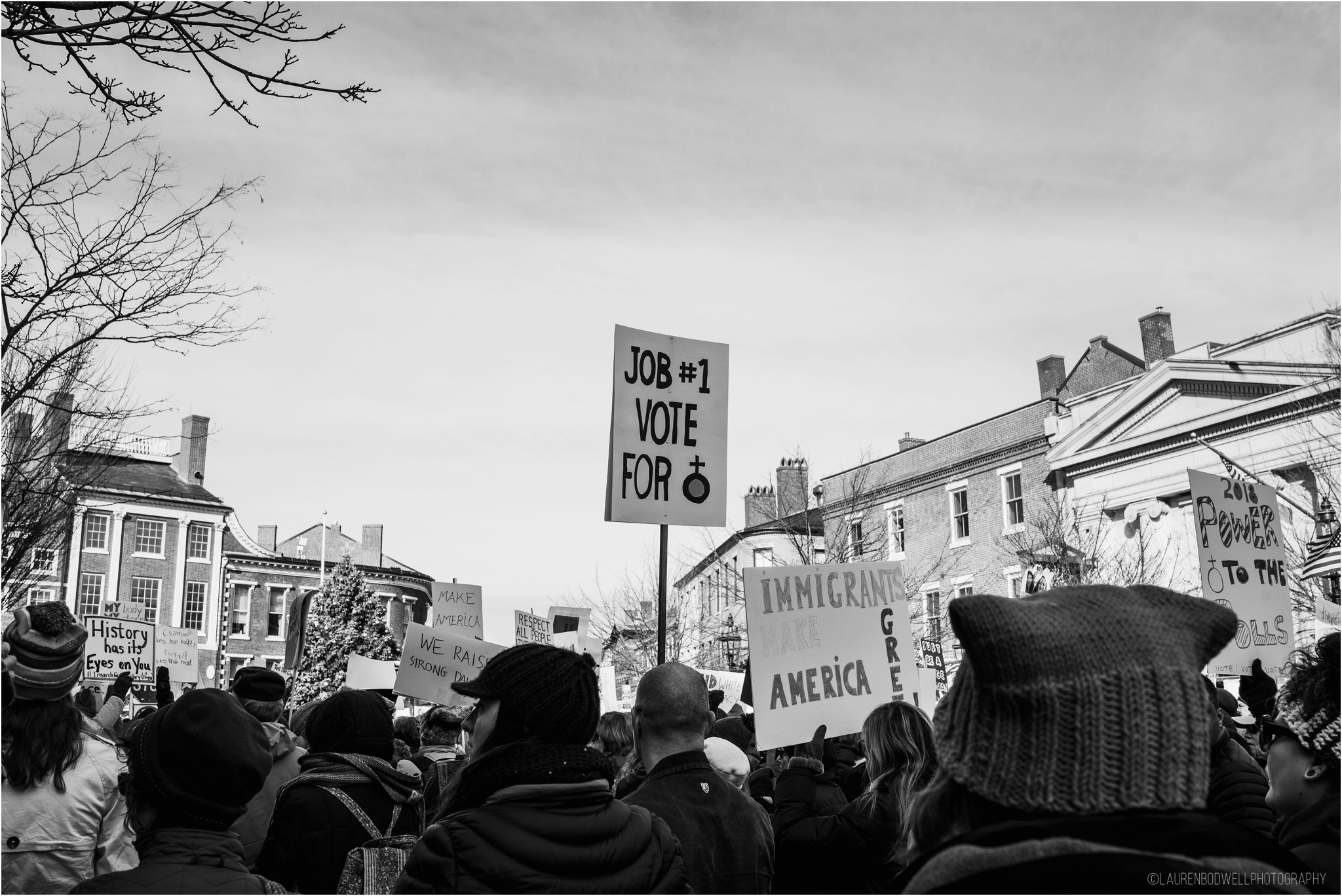 people gathered holding signs