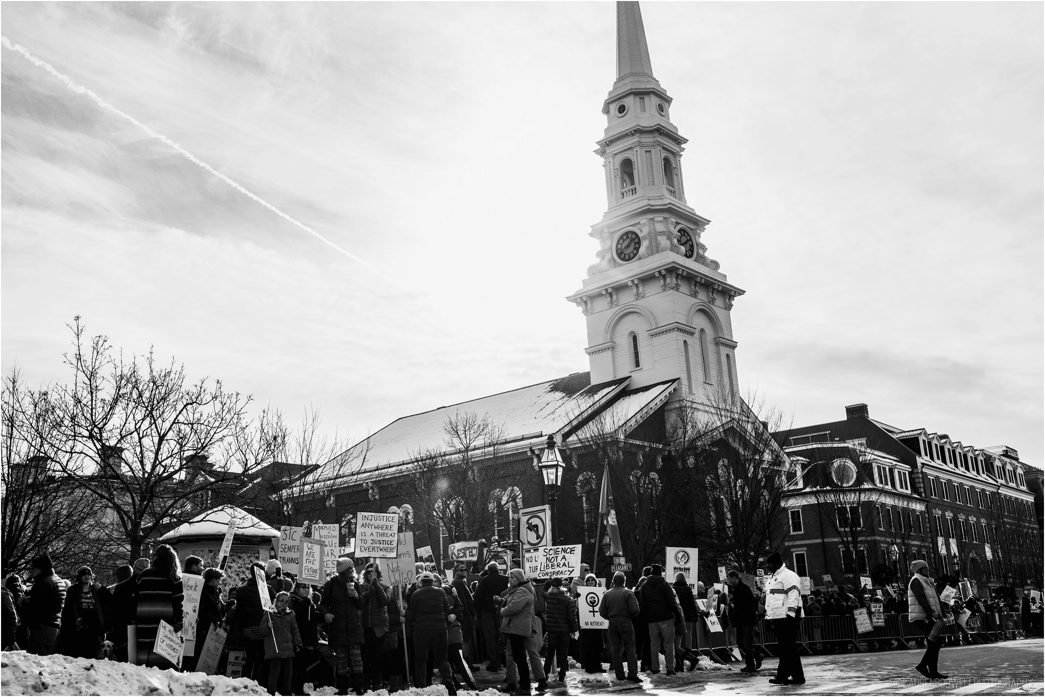 people standing around holding signs in portsmouth